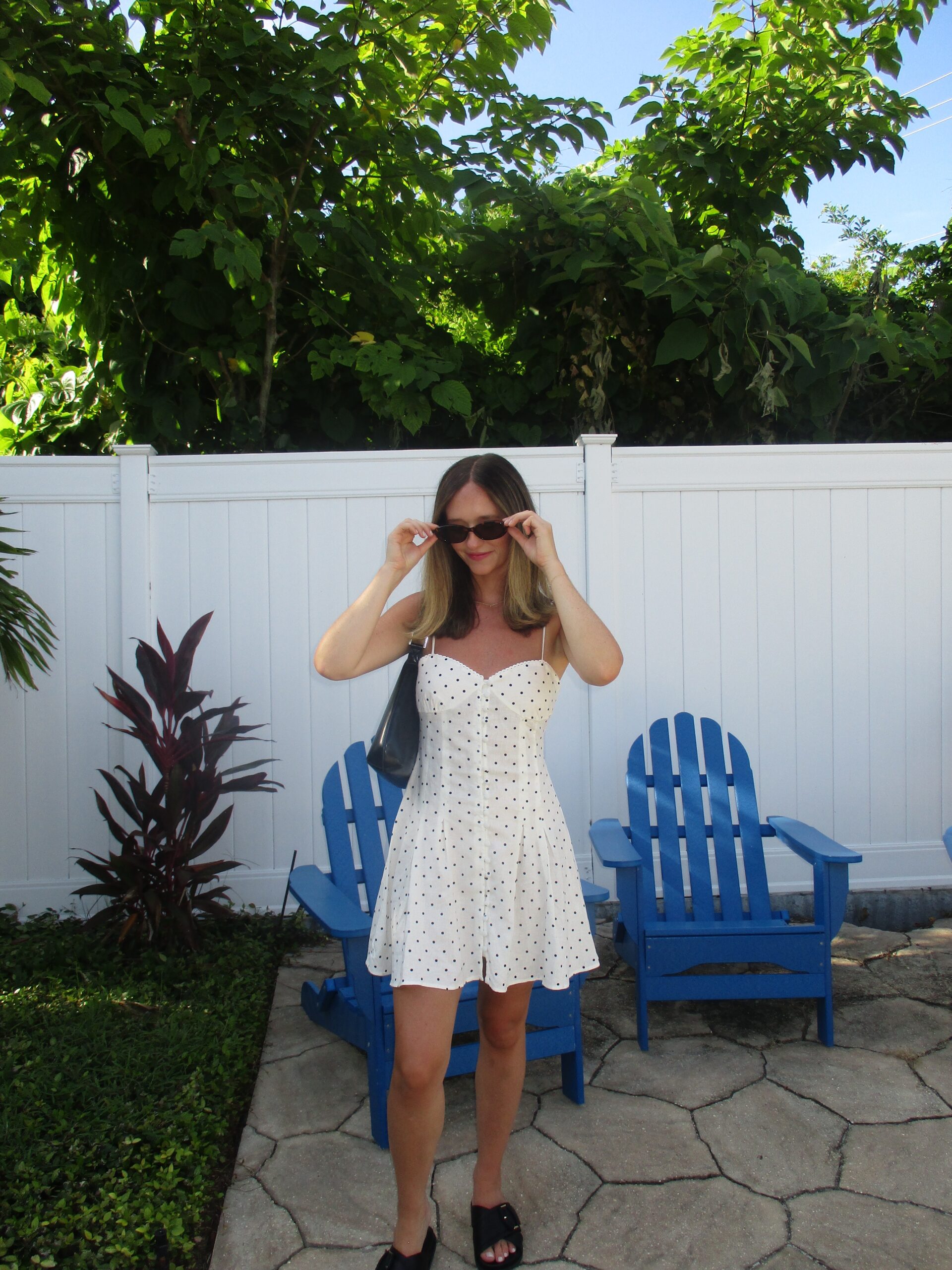 Five budget friendly Amazon dresses for $50 or less accessorized with stylish accessories : a simple black dress in heels and jewelry, a brown print dress in boots and rings, a light blue dress in pearl earrings and a beige bag, a lavender dress in sneakers and a tote, and a fun polka dot dress in silver hoops and bangles. Ideal girly fashion outfit inspiration for 2025.