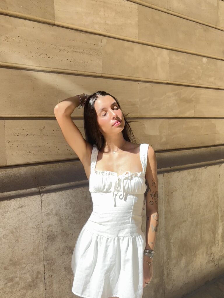 Five girly mini dress outfit inspiration with white, black, wine red, blue, and pink mini dresses paired with fashionable jewelry, bags, hair accessories, sneakers, and heels. Perfect for everyday wear, date nights, and night out strolls